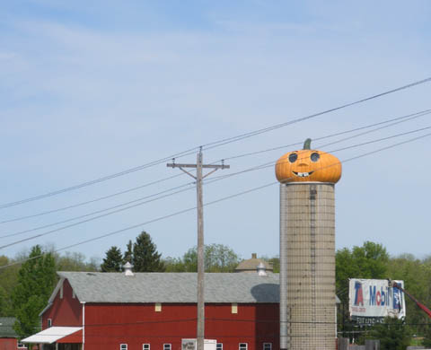 A barn and silo. The silo top was made to resemble a giant jack-o-lantern