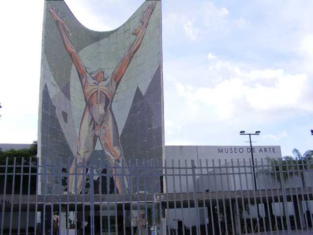 The museum of art is a windowless grey building                   behind a towering mosaic of a nude man dedicated                   to the revolution