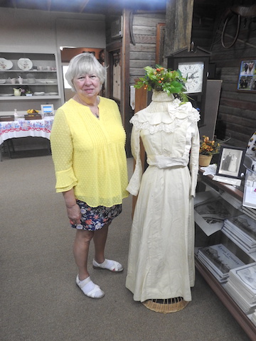 Eunice is standing to the side of a mannequin wearing the dress