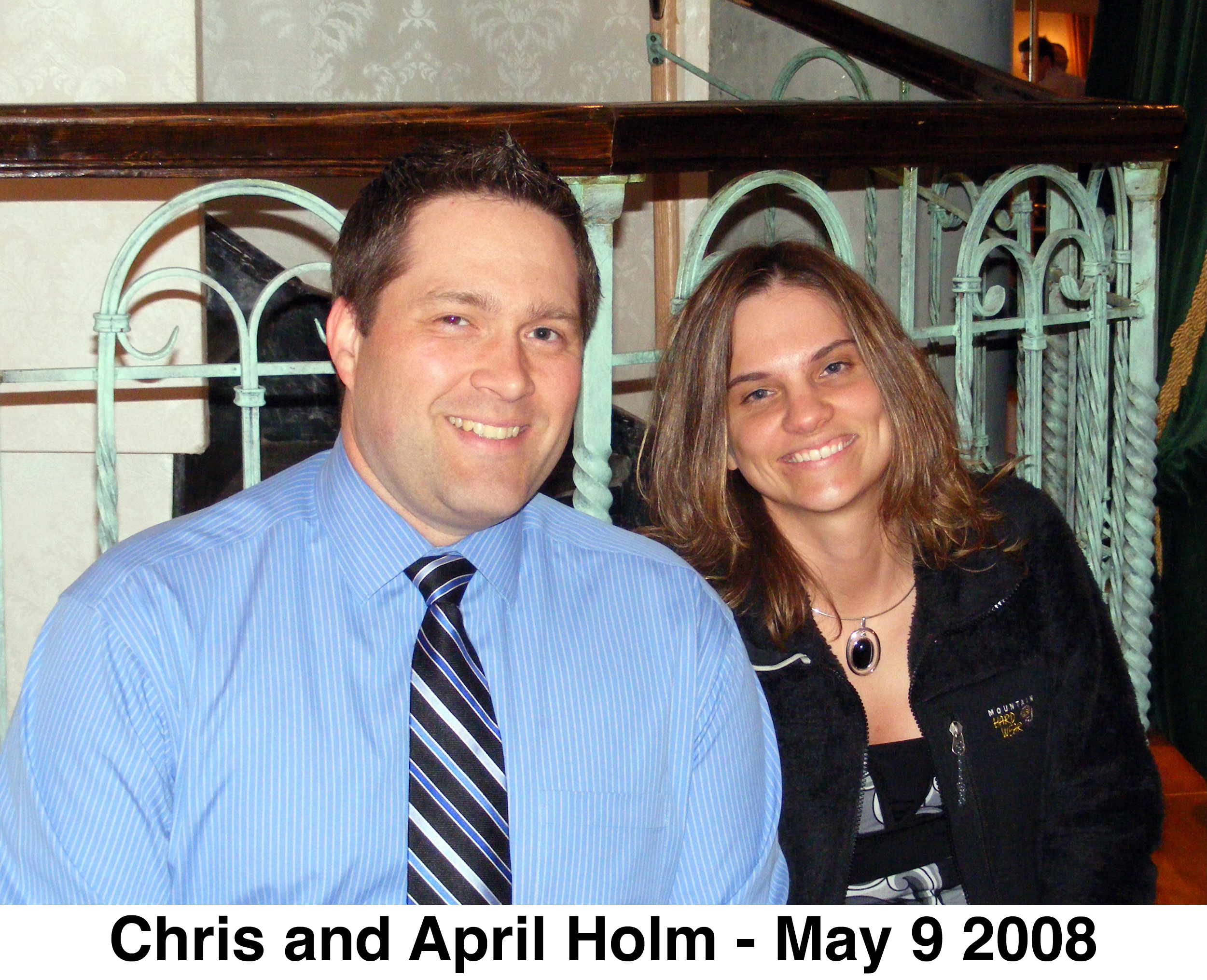 The photo shows the heads of the two looking at the camera.
            Chris is wearing a tie.