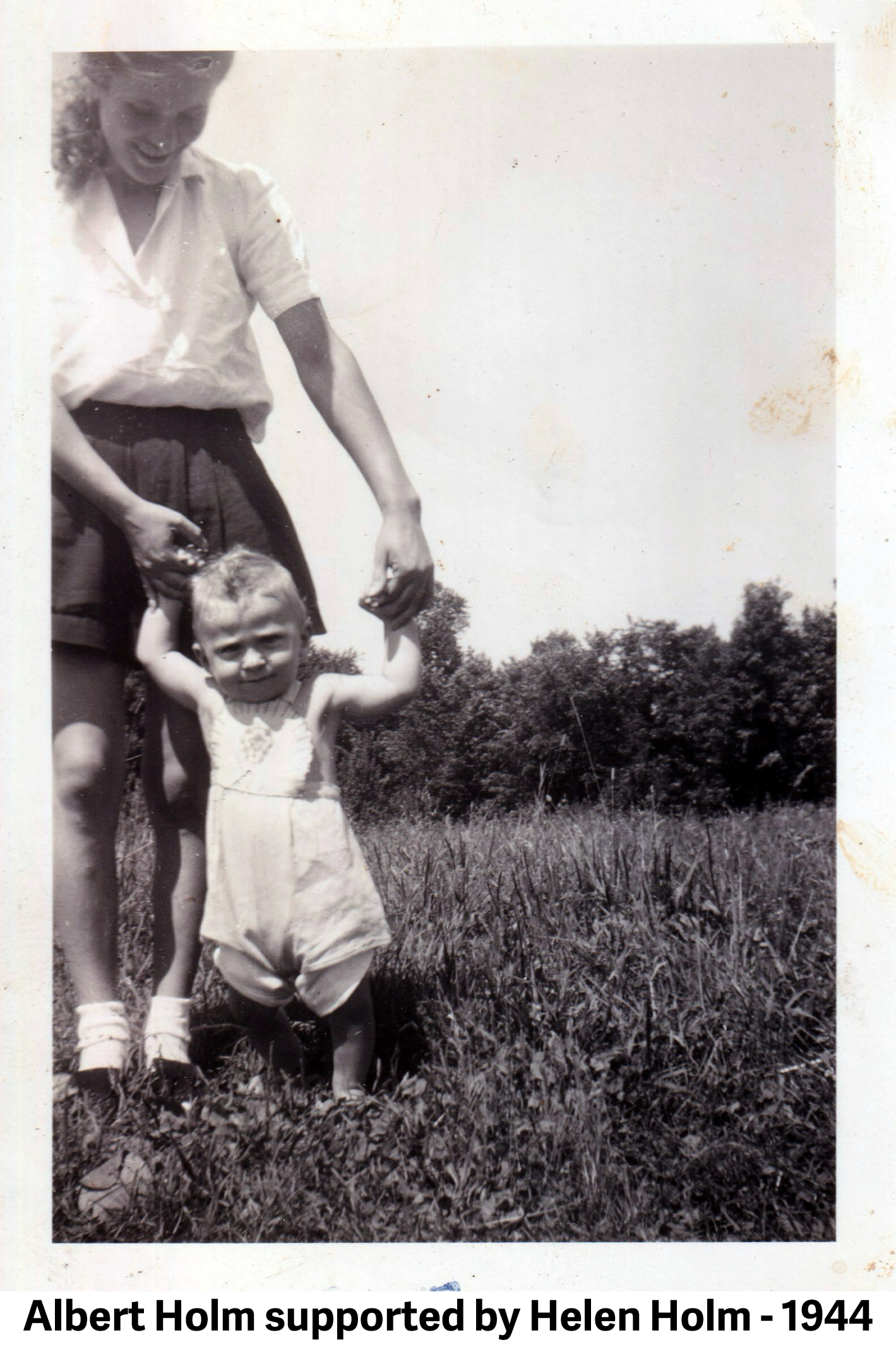 Albert’s mother Helen Holm helps him stand during summer 1944