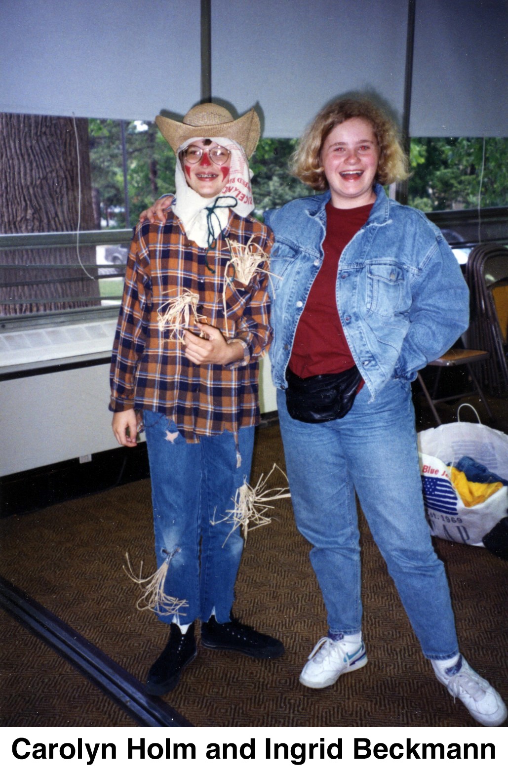 CJ is wearing a scarecrow costume and Ingrid is smiling next to her