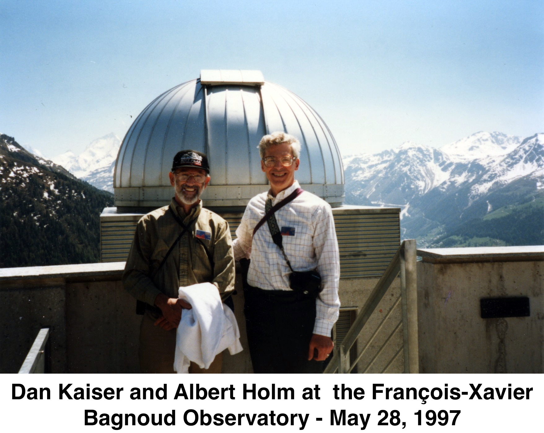 We are standing in front of the observatory dome with the snow-capped peaks
        of the Alps behind us.