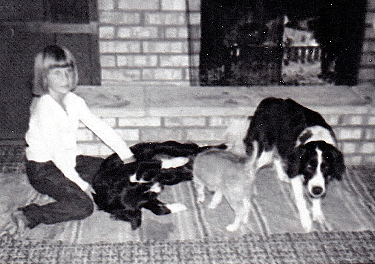 Terri is sitting by the fireplace. She’s rubbing Lady’s
       belly. Lucky is looking todard the photographer.