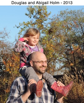 Doug Holm is giving his daughter Abby a ride on his shoulders 