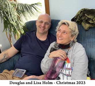 A photo of Doug and Lisa Holm sitting together on Christmas 2023