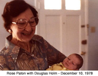 Rose Paton holds infant grandson, Douglas Holm, and smiles 