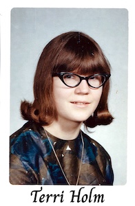 A color school photo of Terri Holm with glasses and long hair