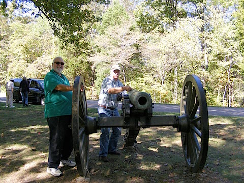 Bob Bower pretends to light the fuse              of one of the cannon in Fort Donelson