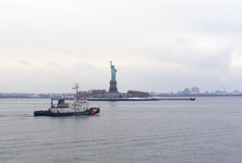 The Statue of Liberty with a Coast Guard vessel - are we free or are we guarded?