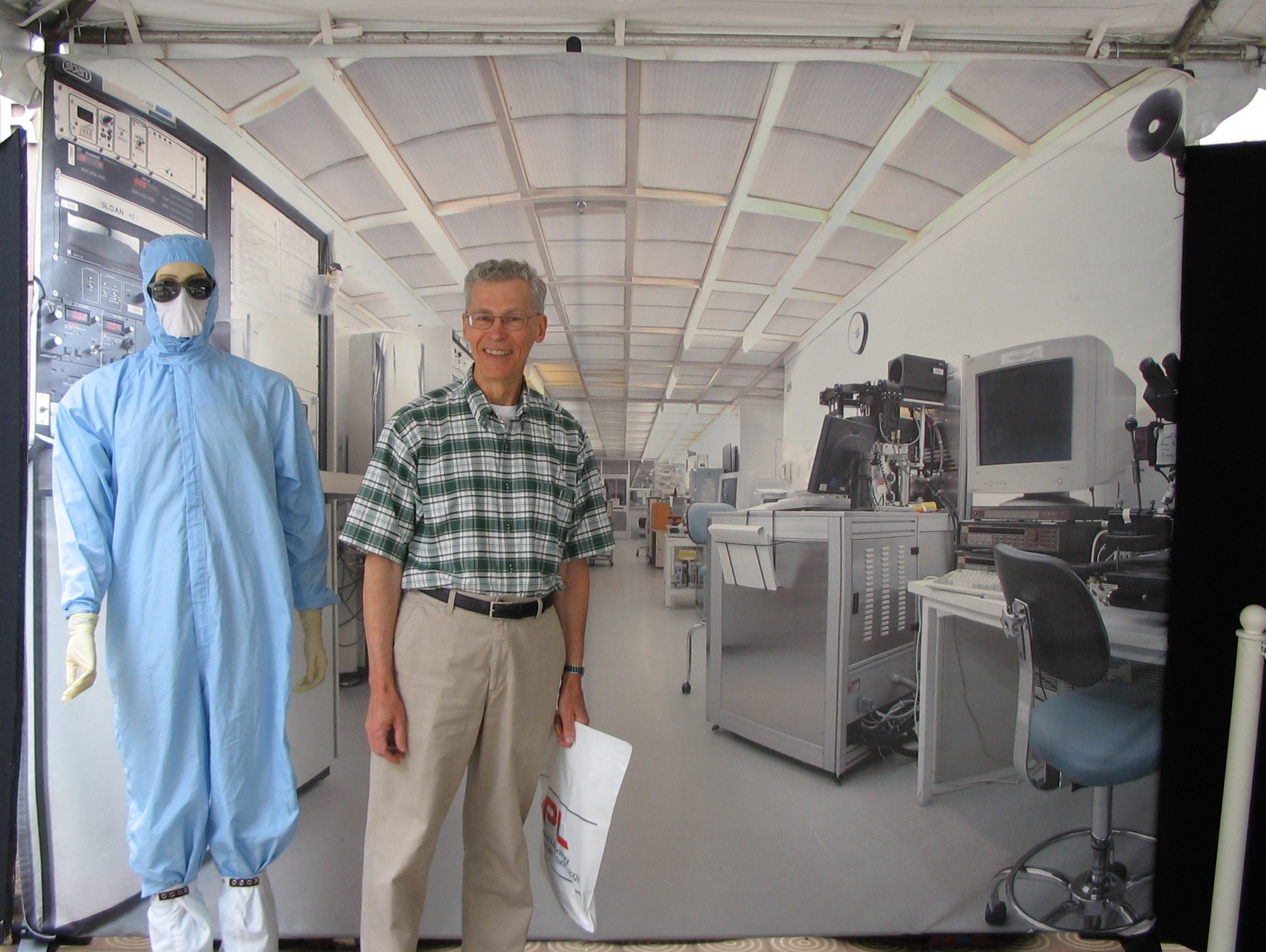 The dummy is dressed in a blue coverall, with a white mask, and dark glasses