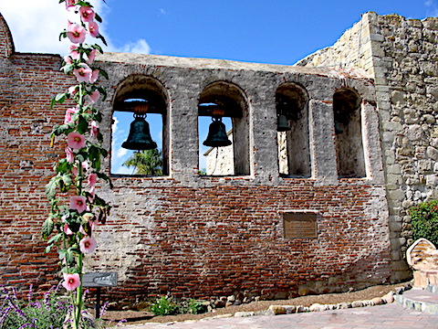 Mission bells hung in alcoves of a wall