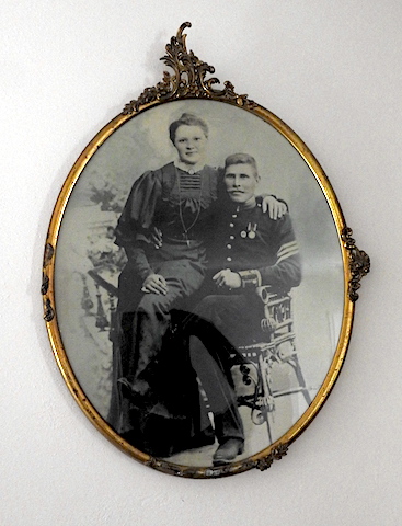 In an oval frame Victor is seated and Frida perched at his side