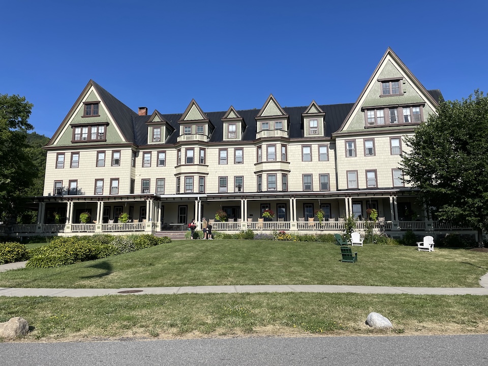 The front of the 4-story building with a wrap-around porch