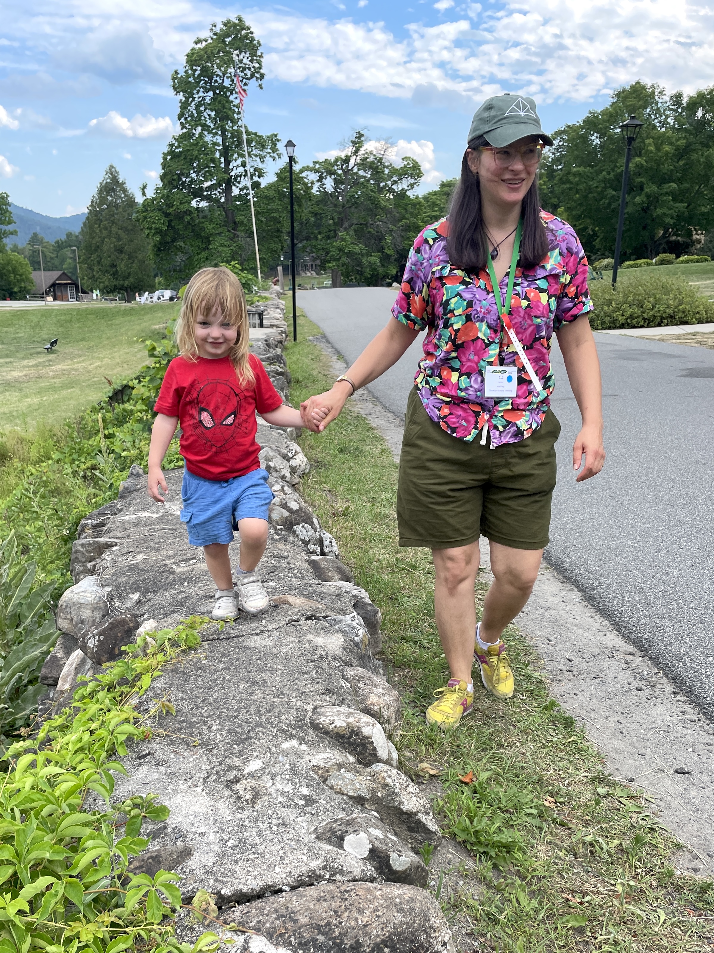Morgan walks toward the camera while holding CJ's hand