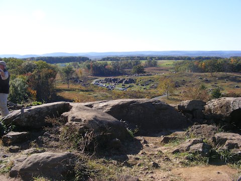 Devil's Den seen from          the Union positions on Little Round Top. The small size of the          cars shows the distance.