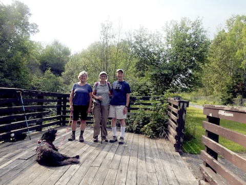 We are gathered on a deck overlooking the Iron River. 
                 Teddy is not looking at the camera