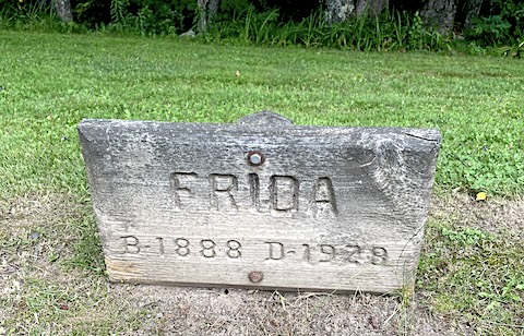 A thick wooden sign reading Frida B 1888 D 1929 