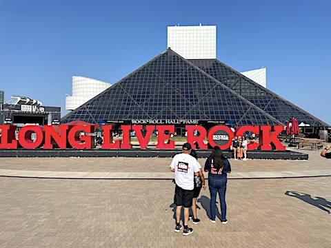 The pyramid shape of the building against a blue sky